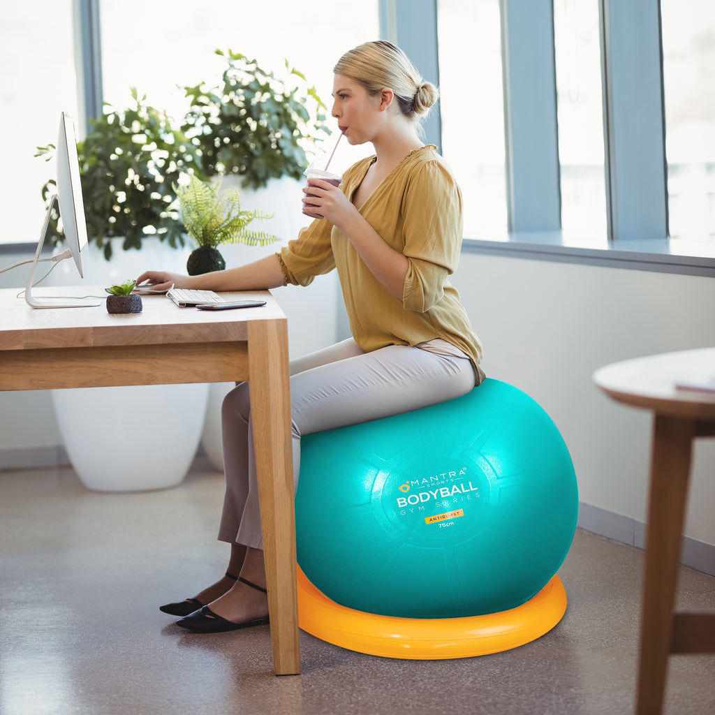 a girl using the exercise ball chair in her home office